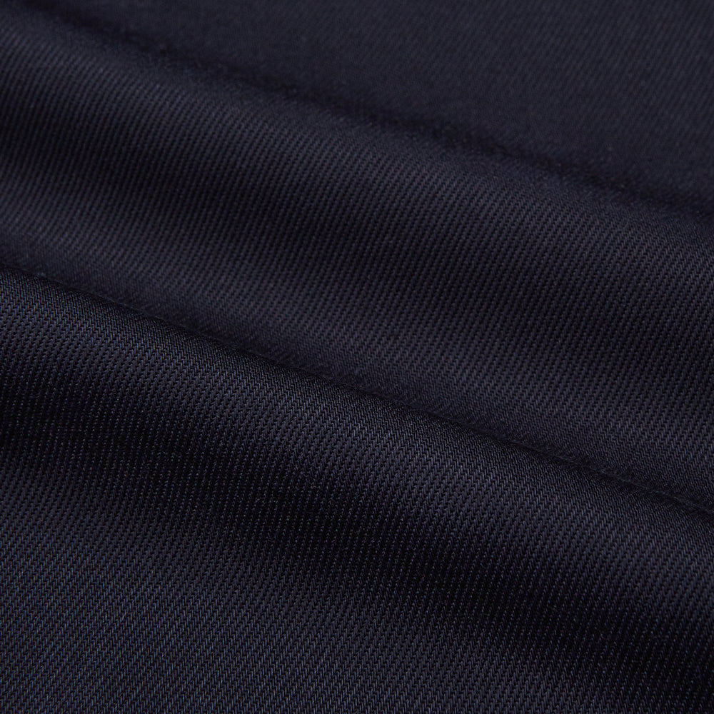 A Navy Cotton Holiday Fit Winnington Shirt by Turnbull & Asser, featuring long sleeves, a chest pocket, white buttons, and a revere collar, is laid flat on a white background.