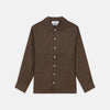 View 1 of product The Turnbull & Asser Chocolate Brown Linen Holiday Fit Fellows Shirt, featuring long sleeves, a classic collar, and white buttons, is displayed flat on a white background—ideal for effortless summer style.