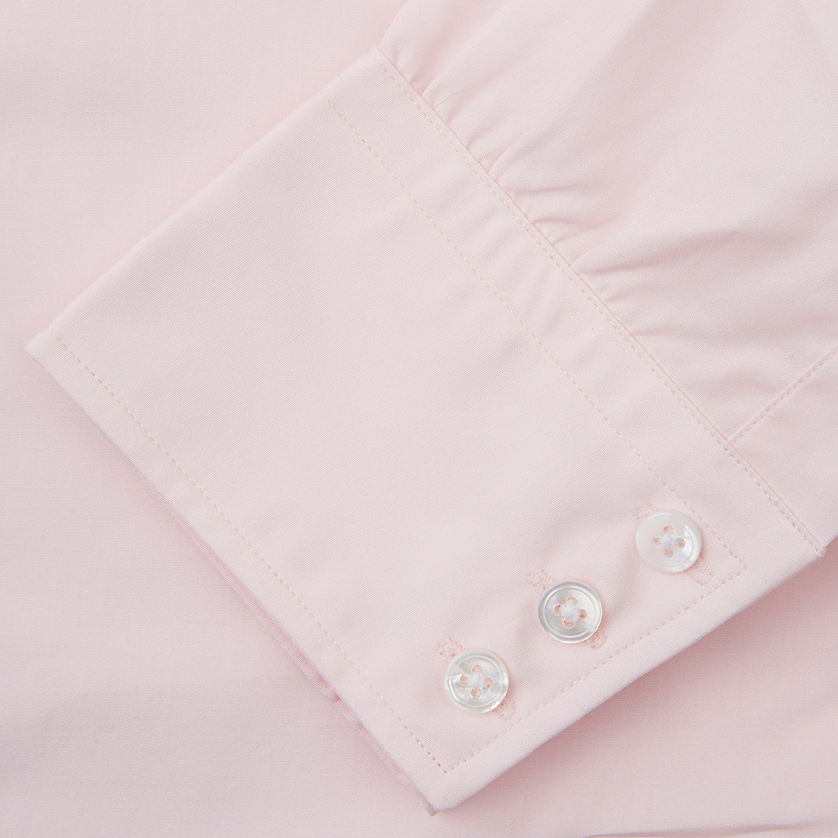 View 3 of product The Turnbull & Asser Pink Cotton Shirt features a T&A collar, 3-button cuffs, and a clean-cut design, displayed neatly folded against a plain white background.