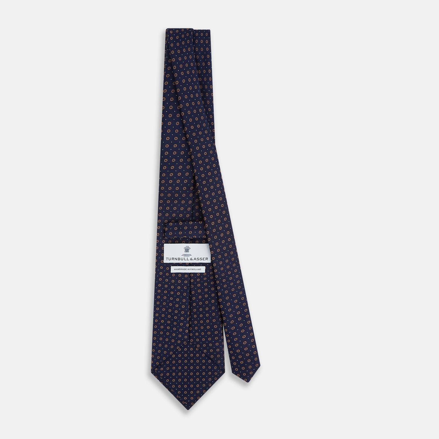 View 4 of product The Turnbull & Asser Navy and Brown Circle Silk Tie features an elegant pattern, perfect for adding a refined touch to your modern office attire.