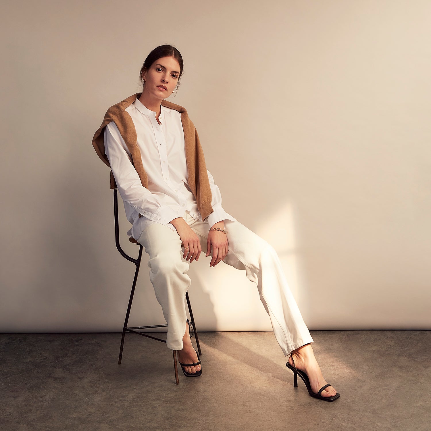 View 13 of product The White Cotton Lauren Shirt by Turnbull & Asser, featuring a stand collar, button-down front, and elongated body, is laid flat on a plain white background.