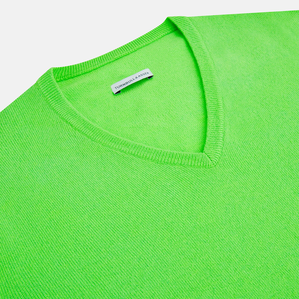 The Turnbull & Asser Bright Green Cashmere V-Neck Jumper features long sleeves with ribbed cuffs and hem—a vibrant addition to your knitwear collection, shown on a plain white background.