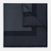 View 1 of product The Turnbull & Asser Navy and Light Blue Dot Silk Pocket Square features white polka dots, a contrasting border, and an inner square design, showcasing handmade craftsmanship with its expertly folded finish.