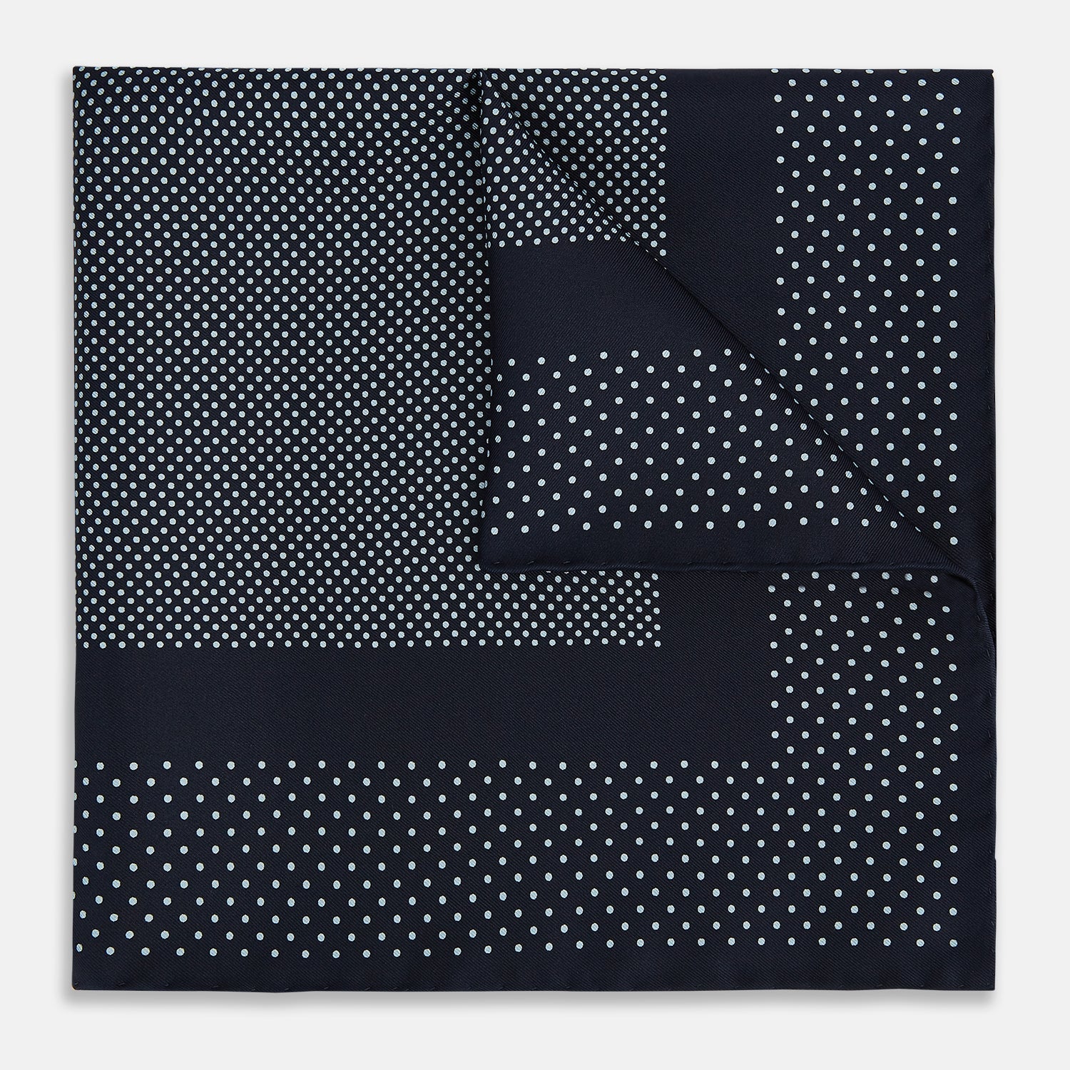 View 1 of product The Turnbull & Asser Navy and Light Blue Dot Silk Pocket Square features white polka dots, a contrasting border, and an inner square design, showcasing handmade craftsmanship with its expertly folded finish.
