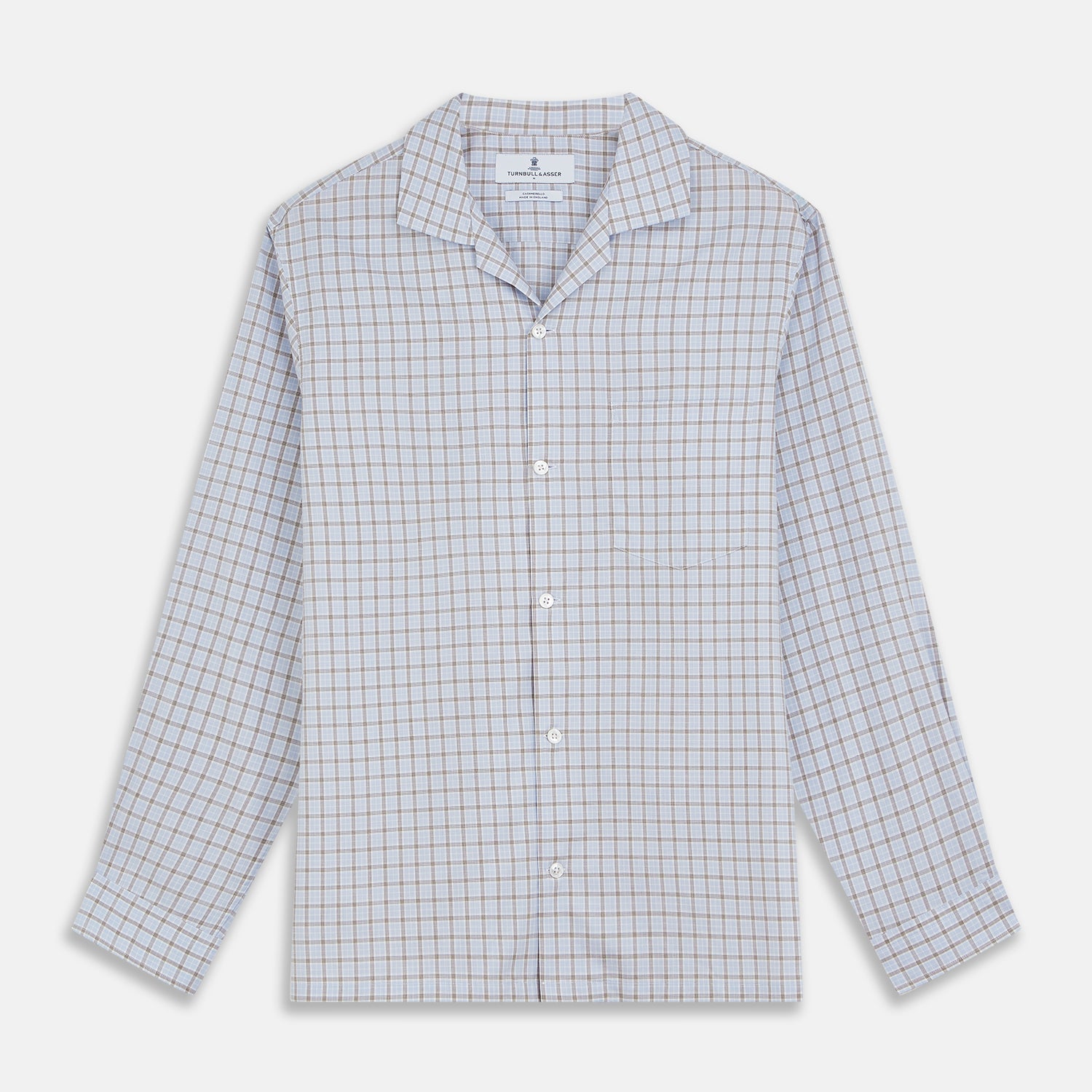 View 2 of product A man wearing glasses and a Pale Blue Multi Check Cashmerello Holiday Fit Winnington Shirt by Turnbull & Asser leans casually against a white countertop, looking at the camera with a neutral expression.