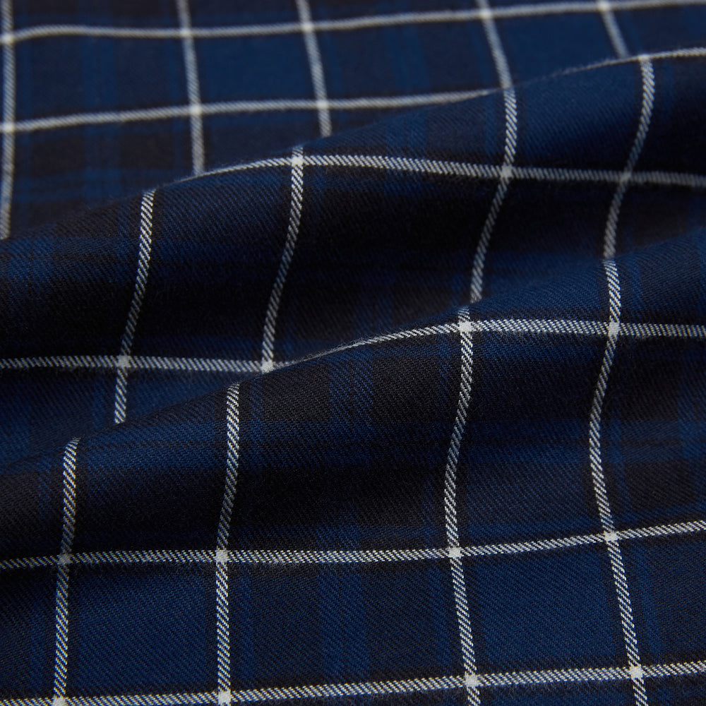 The Turnbull & Asser Navy and White Check Windsor Shirt features a long-sleeve design with a navy base and white check pattern, showcasing British craftsmanship and displayed on a white background.