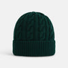 View 1 of product The Forest Green Cable Knit Cashmere Beanie by Turnbull & Asser features a chunky texture and thick ribbed fold-over cuff, shown on a plain white background.