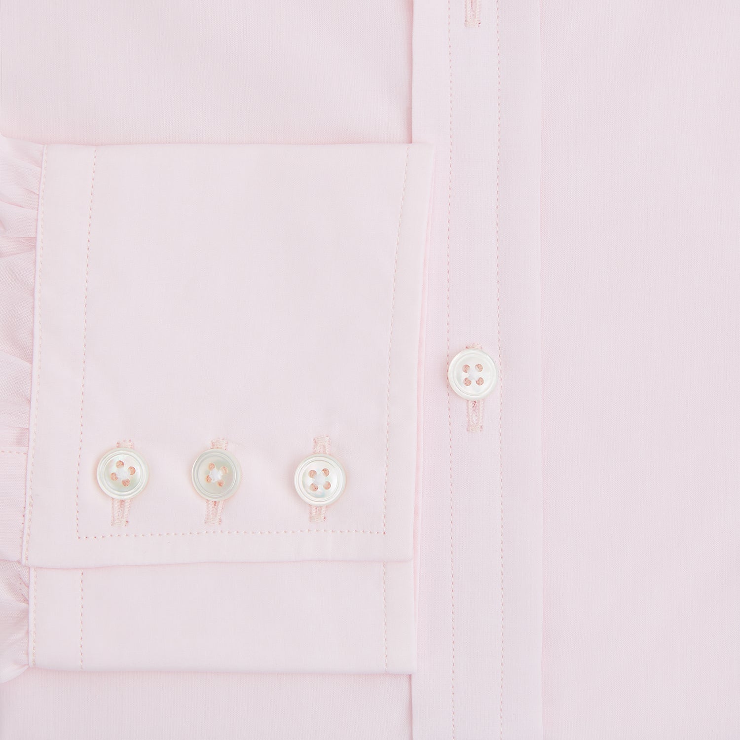 View 4 of product The Turnbull & Asser Pink Mayfair Shirt features long sleeves, a classic collar, and white buttons—a refined choice for any men's wardrobe. Laid flat against a white background, it highlights timeless style and craftsmanship.