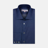 View 1 of product The Turnbull & Asser Dark Blue Denim-Cashmere Shirt features a Regent collar, long sleeves, and 3-button cuffs, neatly folded and displayed on a plain light background.