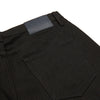 View 2 of product A pair of Turnbull & Asser Black Italian Selvedge Denim Jeans with a five-pocket design, button closure, and cuffed hems, displayed flat on a white background.