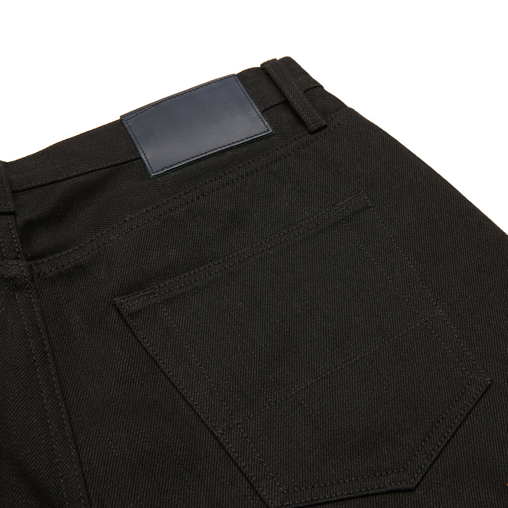 A pair of Turnbull & Asser Black Italian Selvedge Denim Jeans with a five-pocket design, button closure, and cuffed hems, displayed flat on a white background.