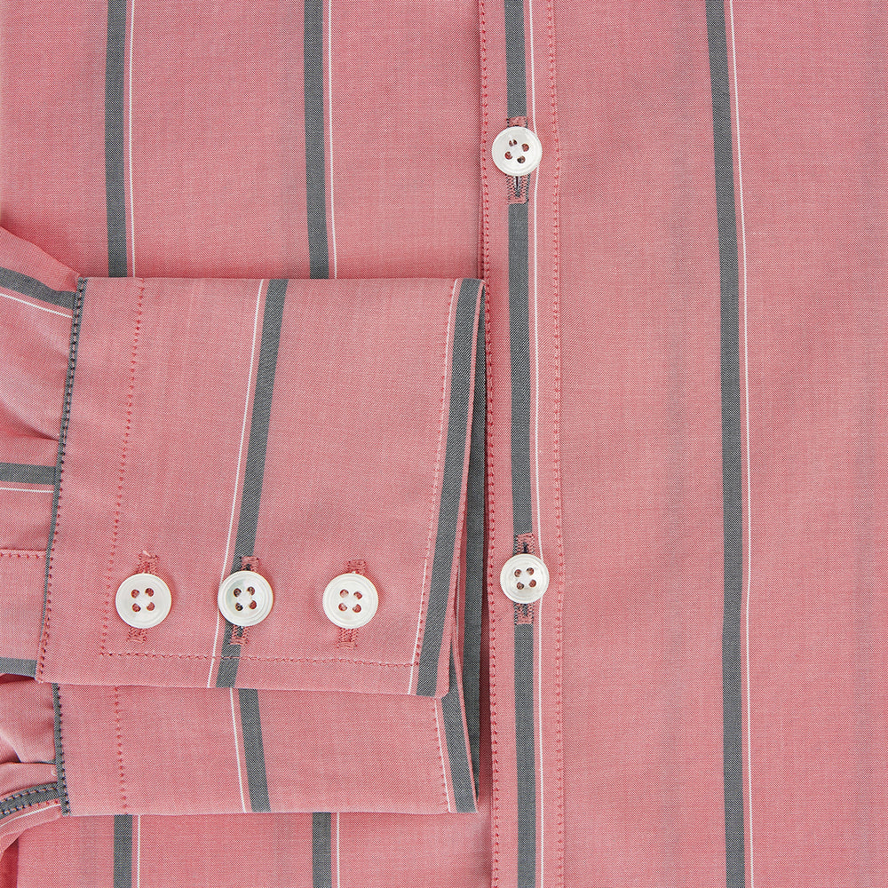 The Coral Pink Track Stripe Westminster Shirt by Turnbull & Asser features vertical navy and white stripes, a tailored fit, pointed collar, and buttoned cuffs—is displayed laid flat on a white background.