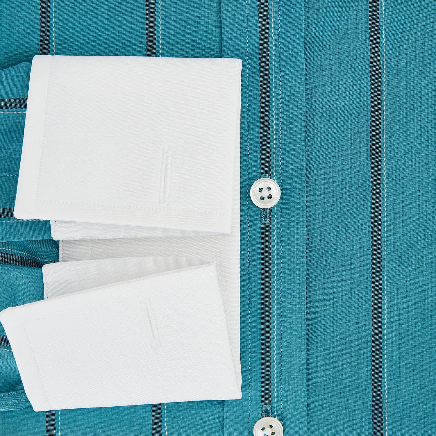 View 4 of product The Turnbull & Asser Turquoise Track Stripe Shirt features a Mayfair fit, contrast white T&A collar and double cuffs, black vertical stripes, and long sleeves, displayed flat on a light background.