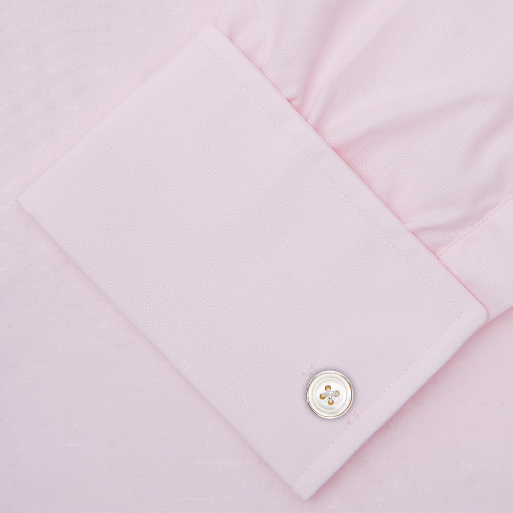 A neatly folded Pink Cotton Shirt with T&A collar and double cuffs by Turnbull & Asser, featuring a classic design with white buttons and an inner label, displayed on a plain white background.