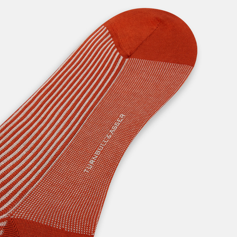 Turnbull & Asser's Rust/White Thin Striped Long Socks feature thin vertical stripes with a solid burnt orange cuff, heel, and toe. A single over-the-calf sock displayed on white background—ideal for those seeking stylish long socks.
