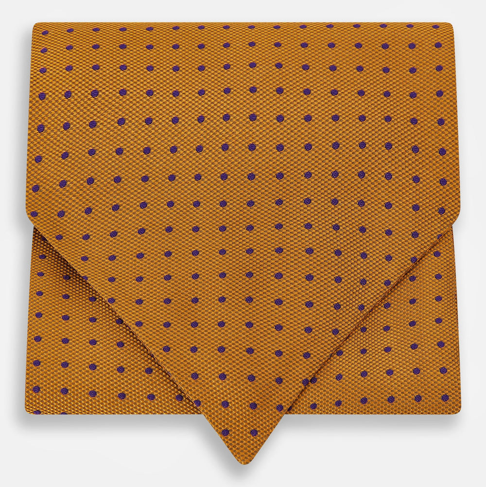 The Navy and Orange Micro Dot Silk Cravat by Turnbull & Asser features a refined pattern of micro dots, bringing color and sophistication to formalwear, displayed against a white background.