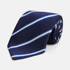 View 1 of product The White and Navy Blazer Silk Tie by Turnbull & Asser features diagonal white and light blue stripes on navy silk, shown rolled on a white background. A refined choice to complement any office shirt.