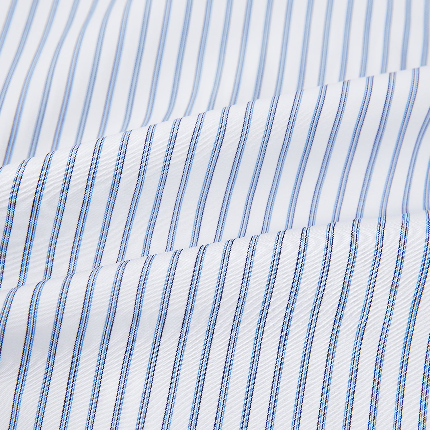 View 6 of product The Turnbull & Asser Navy Double Pinstripe Mayfair Shirt is a long-sleeve, button-up collared shirt with thin vertical blue and white stripes, shown against a plain white background.