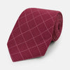 View 1 of product The Turnbull & Asser Burgundy Dotted Check Pattern Printed Silk Tie is shown rolled up on a plain white background.