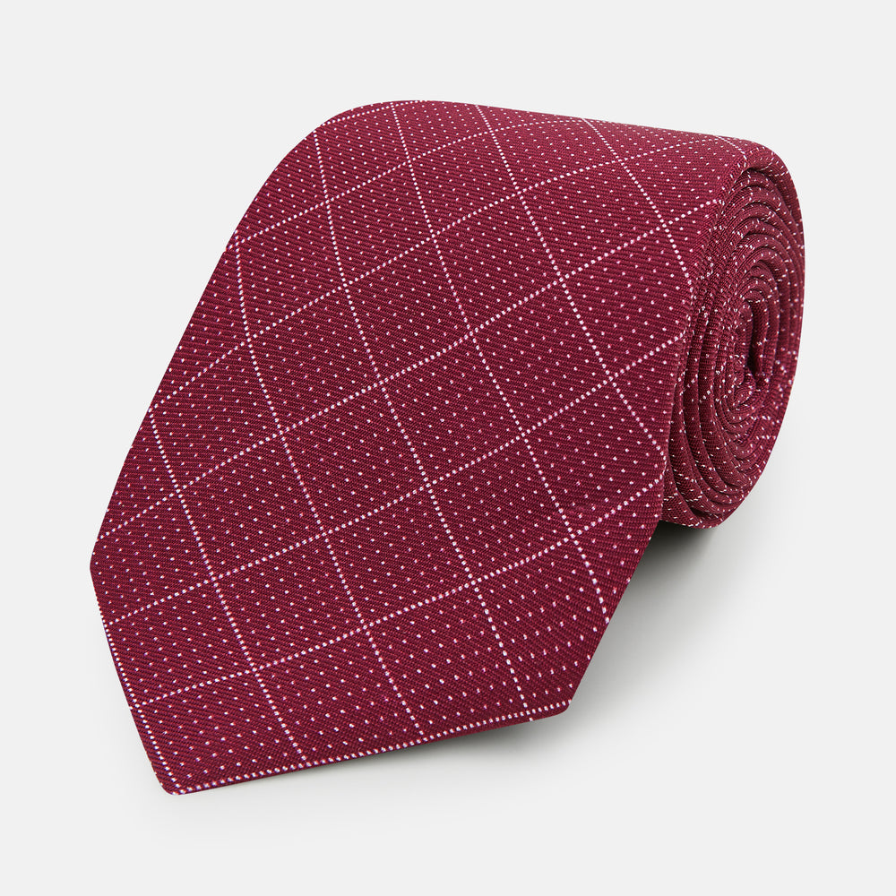 The Turnbull & Asser Burgundy Dotted Check Pattern Printed Silk Tie is shown rolled up on a plain white background.