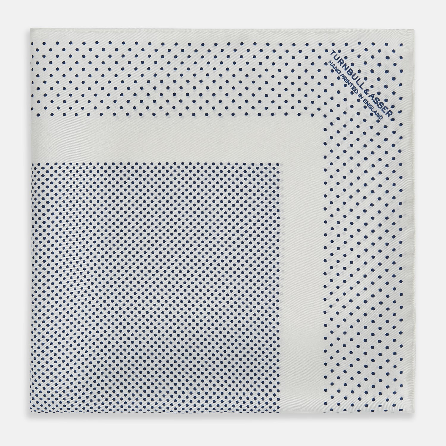 View 3 of product The Turnbull & Asser Cream Dot Silk Pocket Square features a neatly folded pure silk design with a border and center pattern of small navy blue polka dots, displayed on a plain white background.