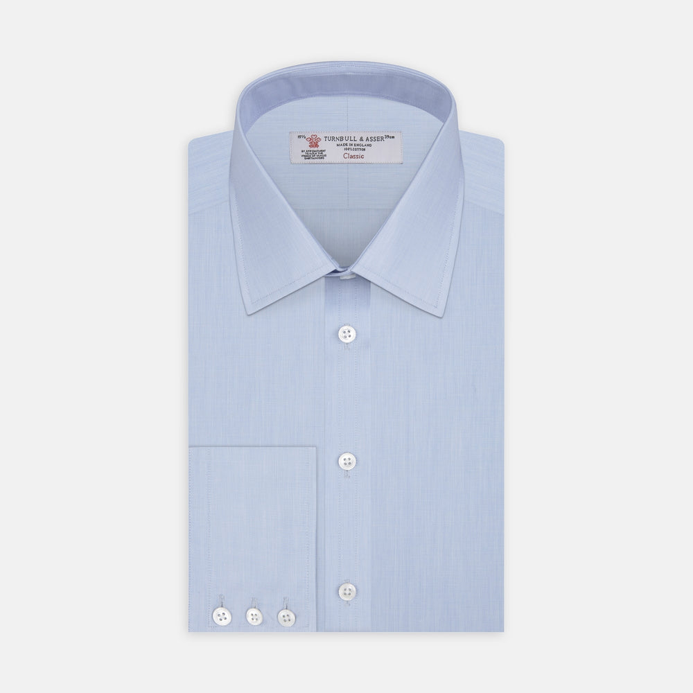 The Turnbull & Asser Light Blue End-on-End Shirt features a T&A collar and 3-button cuffs, neatly displayed against a plain white background—ideal for pairing with a navy suit.