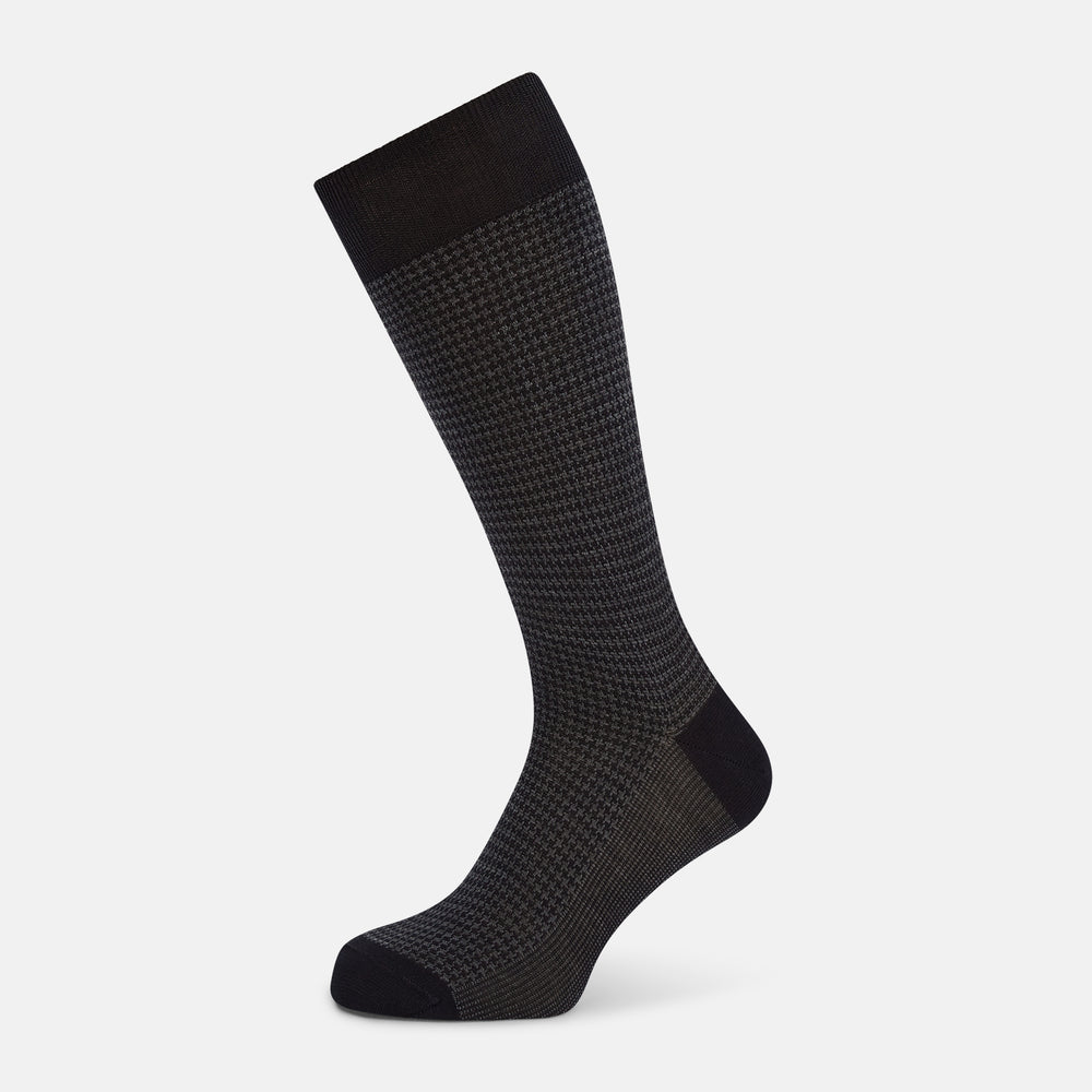 The Turnbull & Asser Charcoal Melange Houndstooth Mid-Length Sock features a black toe, heel, and cuff, and is shown singly against a plain white background.