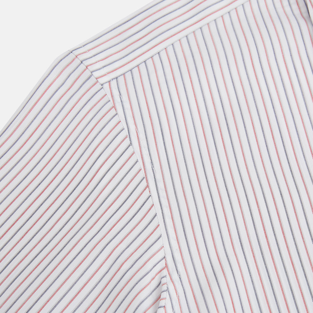 The Turnbull & Asser Red and Blue Double Stripe Westminster Shirt is a long-sleeved, button-up dress shirt with a formal collar, featuring narrow red and blue stripes on white, shown against a plain white background.
