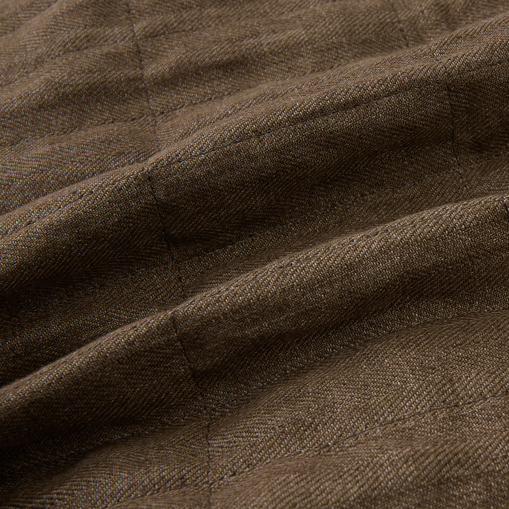 The Turnbull & Asser Pine Cone Quilted Linen Herringbone Waistcoat features a brown, sleeveless design with dark buttons, two angled side pockets, and a chest pocket, shown on a plain white background.