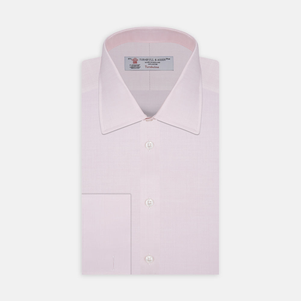 The Turnbull & Asser Pink Herringbone Superfine Cotton Shirt features a T&A collar, double cuffs, and clean-cut design, displayed neatly folded against a white background.