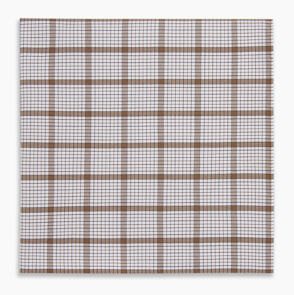 The Turnbull & Asser Hand Rolled Brown Overlay Check Handkerchief is a rectangular white cotton accessory with evenly spaced brown and black grid lines, forming squares—a timeless classic for gentlemen.