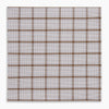 View 4 of product The Turnbull & Asser Hand Rolled Brown Overlay Check Handkerchief is a rectangular white cotton accessory with evenly spaced brown and black grid lines, forming squares—a timeless classic for gentlemen.