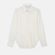 The Cream Silk Tailored Bianca Shirt by Turnbull & Asser features long sleeves, a pointed collar, and curved hem in soft-touch peace silk with a tailored fit. Shown laid flat on a white background.