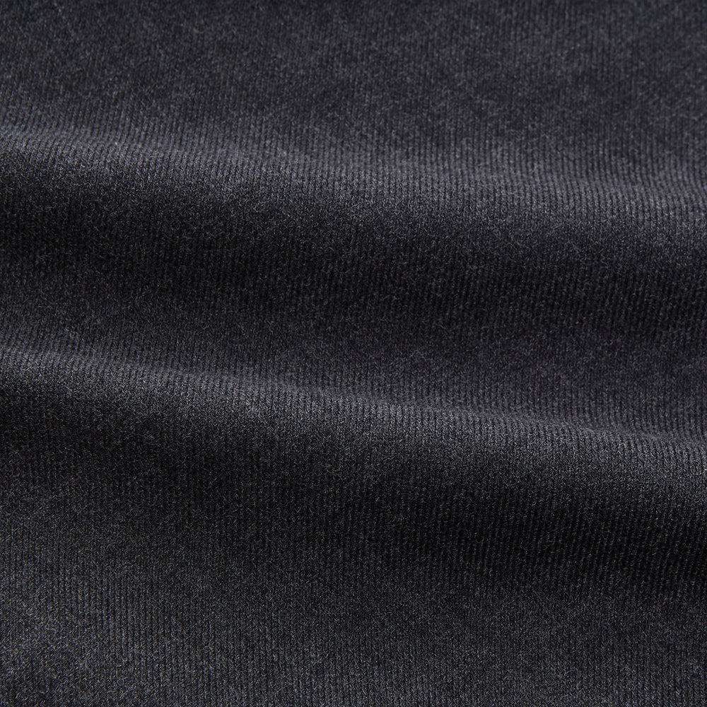 The Turnbull & Asser Charcoal Cotton Blend Weekend Fit Blake Shirt is a long-sleeve, stand-collar shirt with white buttons. Its minimalist design, with no pockets or patterns, makes it perfect for casual wear. Displayed flat on a white background.