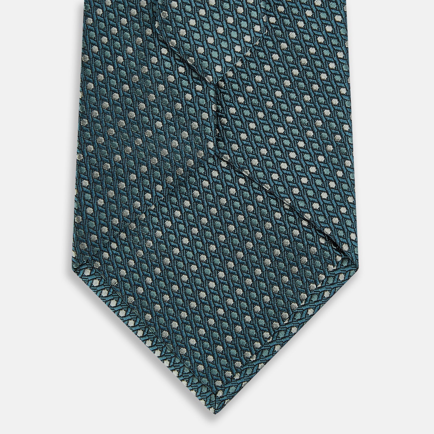 View 3 of product The Turnbull & Asser Teal Micro Hexagon Silk Tie showcases a textured geometric dot and subtle hexagon pattern, adding a refined touch to any tailored look.