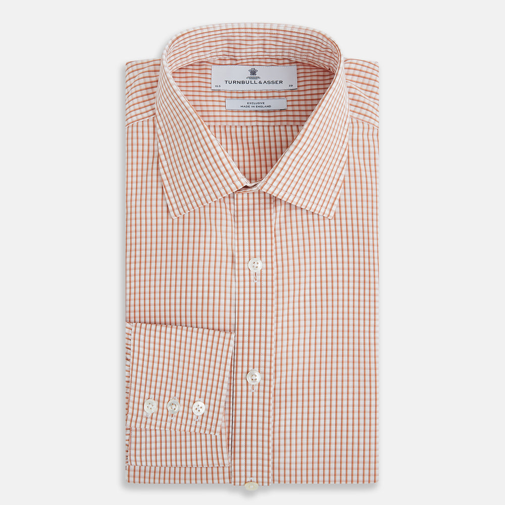 The Orange Micro Shadow Check Mayfair Shirt by Turnbull & Asser features a T&A collar, button-down front, and buttoned cuffs; crafted from Italian cotton in an orange and white check pattern, laid flat on a white background.