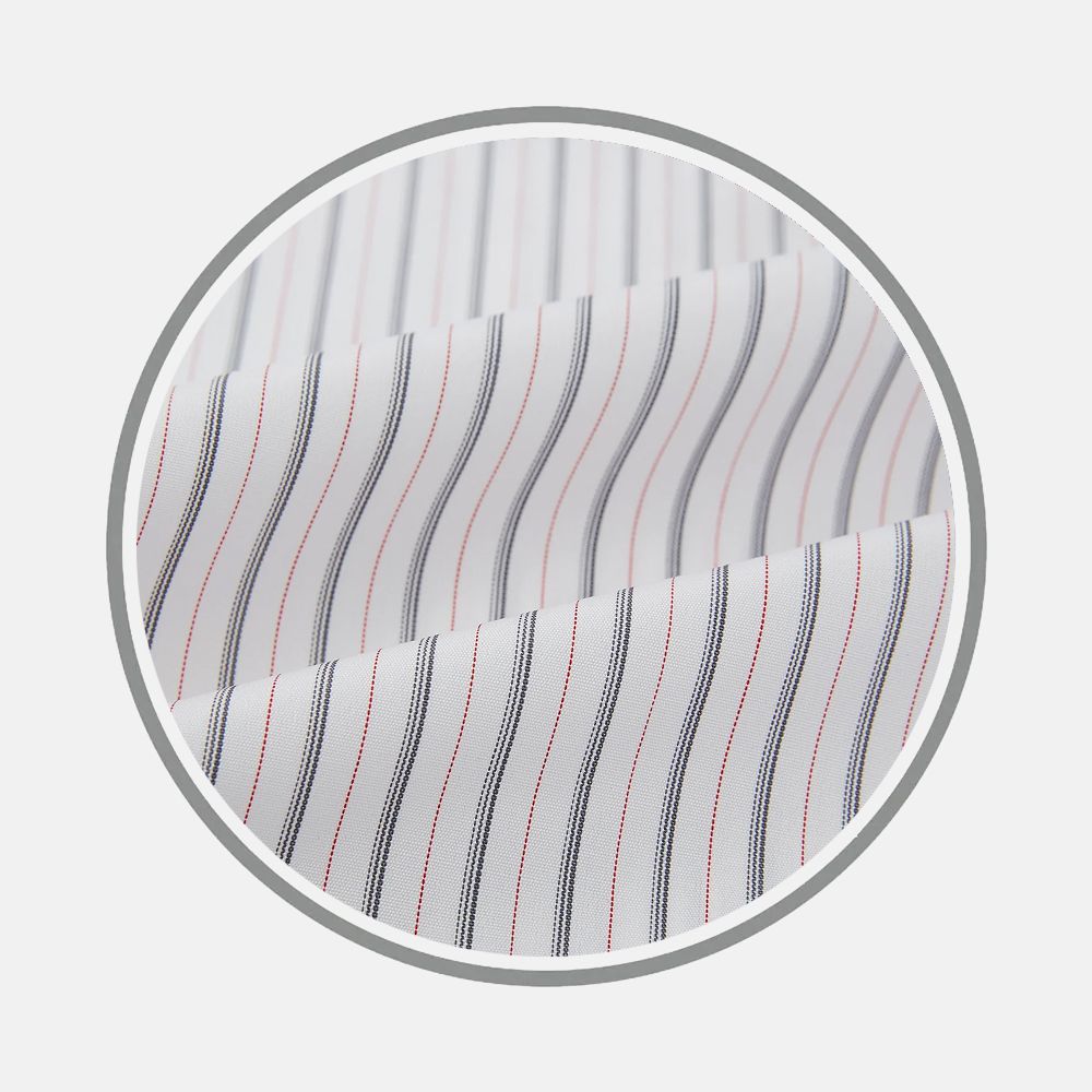Close-up of Turnbull & Asser’s Midnight Blue And Red Ticking Stripe Fabric, featuring thin vertical blue and red stripes on white, displayed in a circular frame with gentle folds against a light gray background.