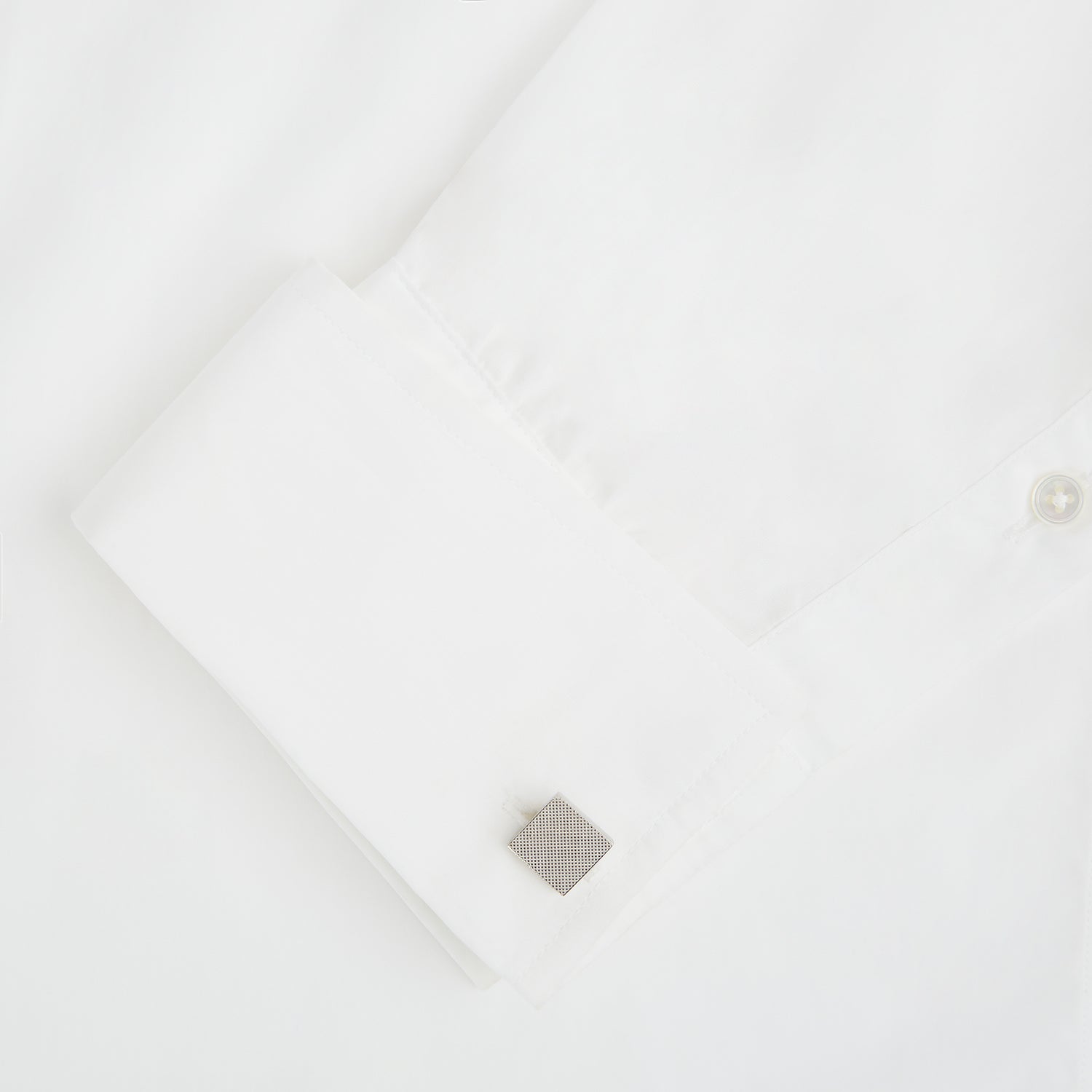 View 3 of product Turnbull & Asser's Silver Textured Square Cufflinks feature a dotted, polished finish and are showcased against a plain white background.