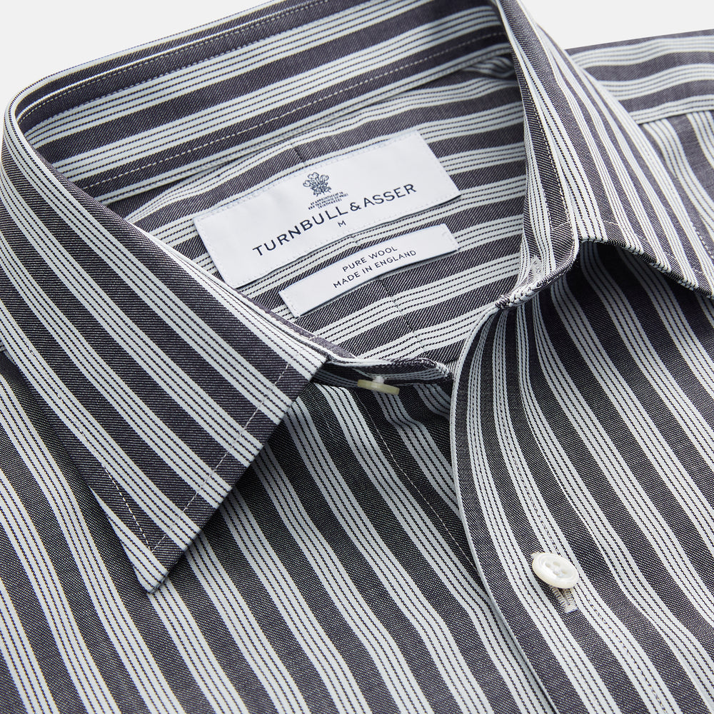 The Turnbull & Asser Navy Multi Stripe Weekend Fit Wool Shirt features a Derby collar, 1 button cuffs, and bold multicolored stripes, shown laid flat on a plain background.