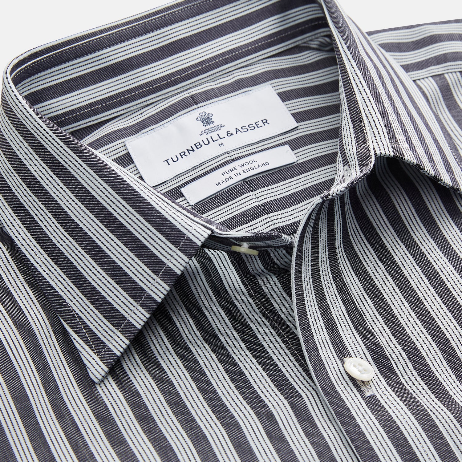 View 2 of product The Turnbull & Asser Navy Multi Stripe Weekend Fit Wool Shirt features a Derby collar, 1 button cuffs, and bold multicolored stripes, shown laid flat on a plain background.