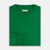 View 7 of product The Turnbull & Asser Grass Green Cashmere Round Neck Jumper features long sleeves, ribbed cuffs, collar, and hem, shown on a white background.