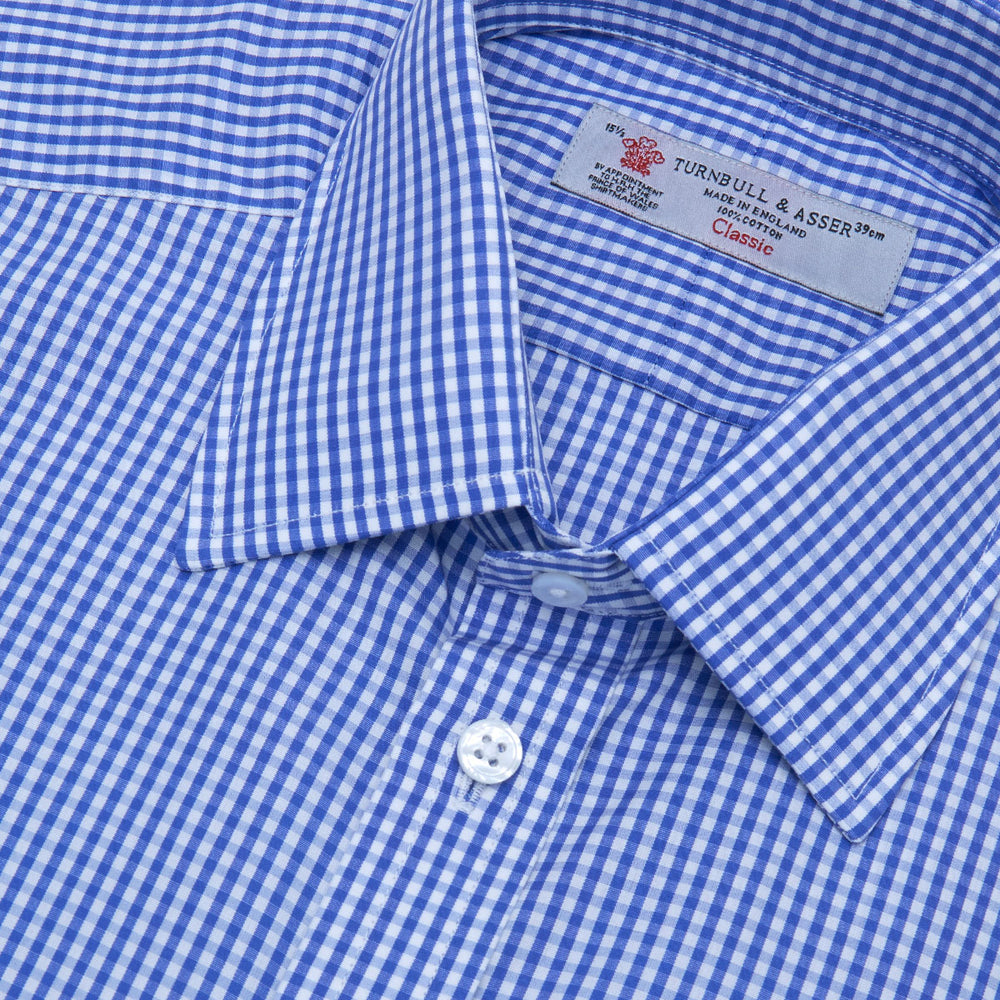 The Turnbull & Asser Mid-Blue Gingham Check Shirt features a T&A collar and 3-button cuffs, crafted from soft cotton and displayed against a plain white background.