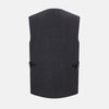 View 3 of product The Turnbull & Asser Ash Linen Twill Waistcoat is a dark gray, sleeveless V-neck with three front buttons, a chest pocket, and two diagonal zippered pockets in subtly textured twill. Shown on a plain white background.
