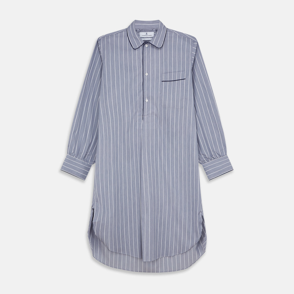 The Turnbull & Asser Pale Blue and White Pinstripe Cotton Blend Sussex Nightshirt pairs classic style with comfort, featuring long sleeves, a collar, front buttons, chest pocket, and curved hemline—perfect for luxury sleepwear.