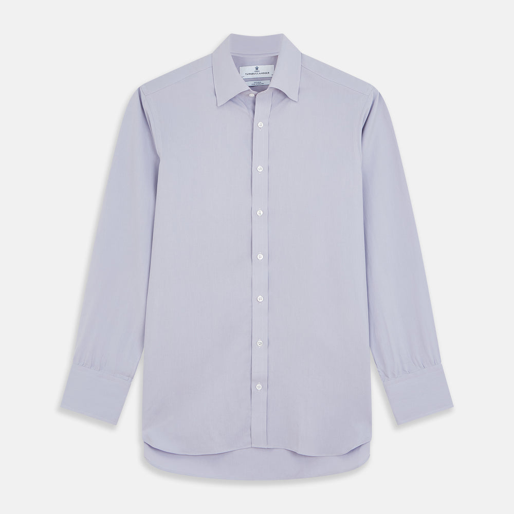 The Turnbull & Asser Lilac Silk Regular Fit Flaxton Shirt features long sleeves, a classic collar, white buttons, and a curved hem, shown laid flat on a white background.