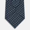 View 3 of product The Turnbull & Asser Navy Floral Tile Pattern Printed Silk Tie features light blue geometric and floral motifs in a diamond grid, elegantly displayed and crafted from fine English silk.