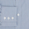 View 4 of product The Turnbull & Asser Pale Blue Micro Graph Check Mayfair Shirt features a small blue and white check pattern, classic T&A collar, white buttons, and buttoned cuffs. Presented on a plain white background.