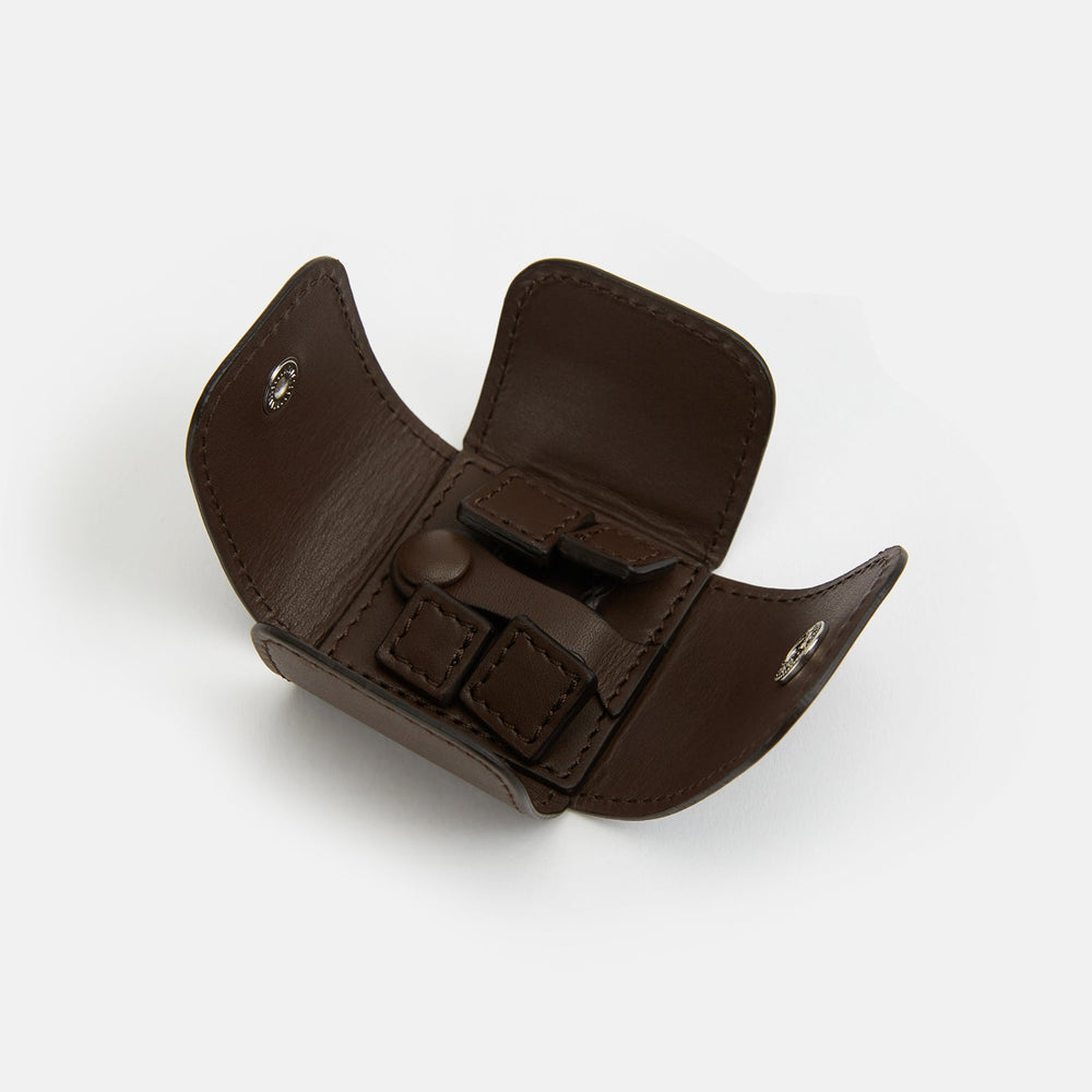 Turnbull & Asser’s Dark Chocolate Leather Cufflinks feature square Italian leather with stitched edges and braided links, perfect for men’s accessories, shown here on a white background.