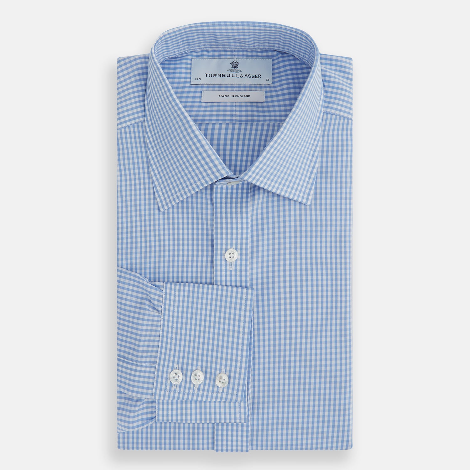 View 4 of product The Turnbull & Asser Light Blue Gingham Check Shirt features a T&A collar, 3-button cuffs, classic gingham pattern, and white buttons down the front, shown laid flat on a white background.