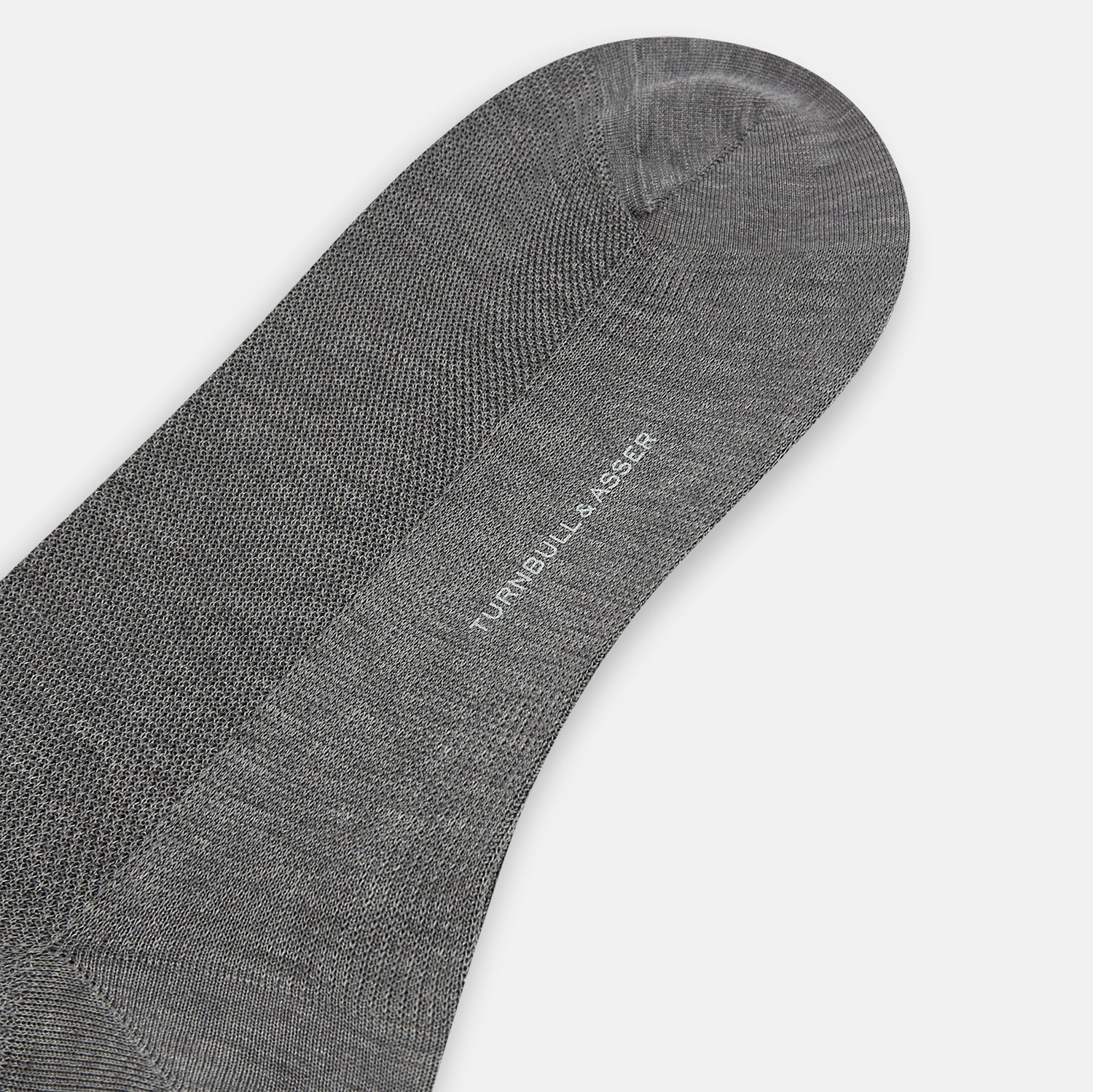 View 3 of product A single Steel Melange Micro Knit Mid-Length Sock by Turnbull & Asser, knee-high and gray, crafted from mercerised Egyptian cotton with a subtle micro knit pattern, is displayed upright on a plain white background.